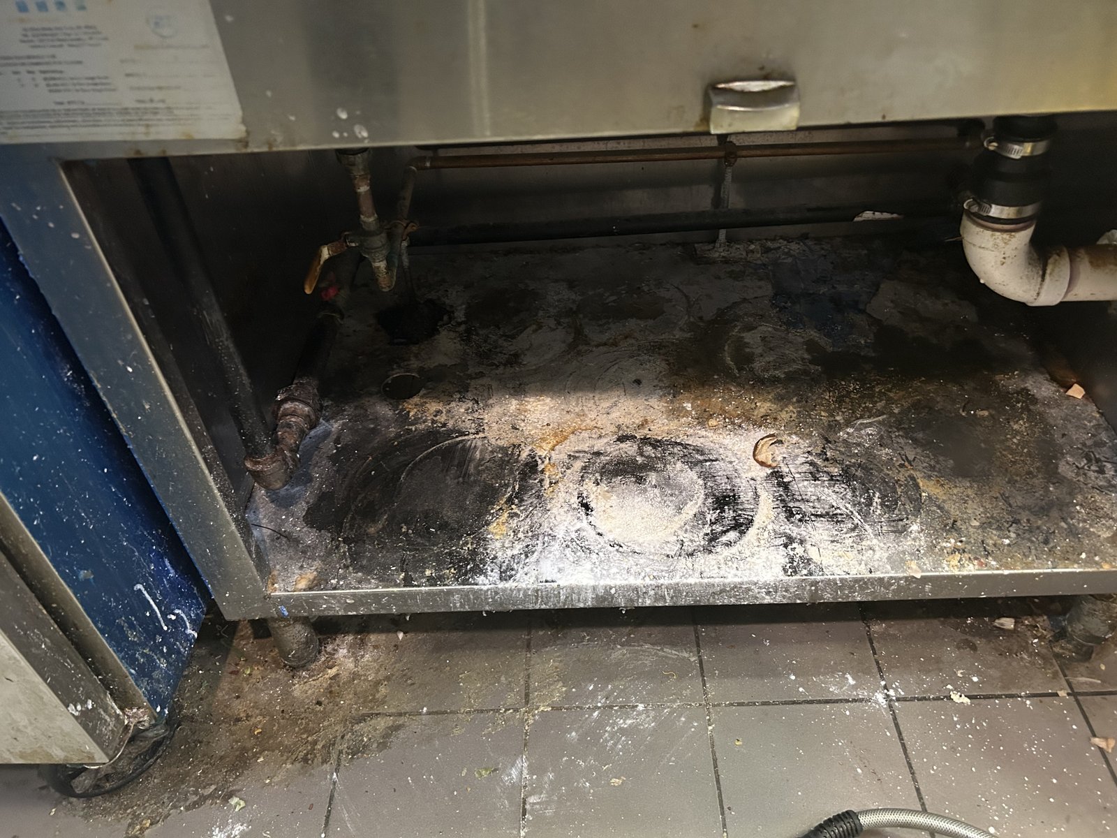 Commercial kitchen exhaust system with accumulated grease and buildup before CKE cleaning